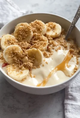 Delicious Banana Pudding Greek Yogurt Bowl topped with fresh bananas and a drizzle of honey