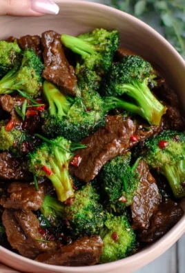 Beef and Broccoli Stir-Fry served on a plate with rice and vegetables.