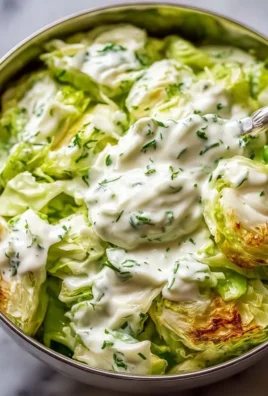 Delicious cabbage salad with yogurt dressing topped with fresh vegetables