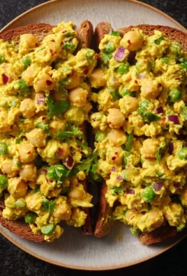 Delicious curried chickpea salad in a bowl with fresh vegetables