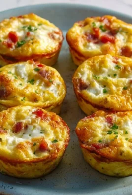 Delicious breakfast egg muffins packed with vegetables and cheese on a plate
