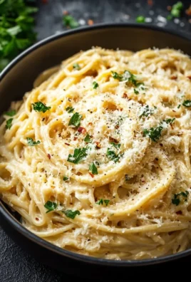 Cheesy Garlic Parmesan Spaghetti served in a bowl with fresh herbs