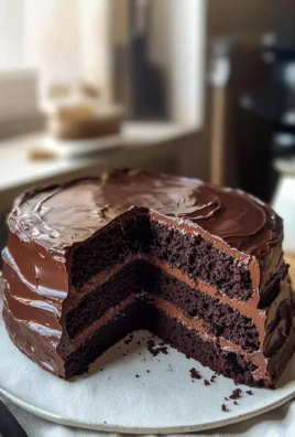 Delicious chocolate fudge cake topped with chocolate ganache and sprinkles
