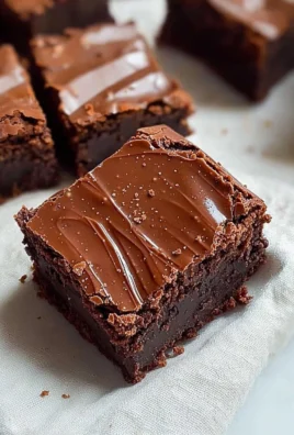 Decadent chocolate ganache brownies topped with smooth chocolate drizzle