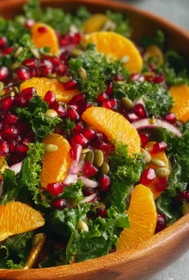 Citrus Pomegranate Kale Salad garnished with fresh citrus and pomegranate seeds.