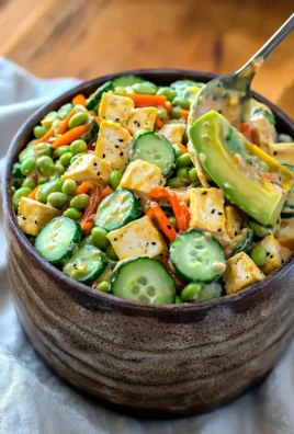 Creamy Asian cucumber salad with fresh vegetables and a savory dressing.