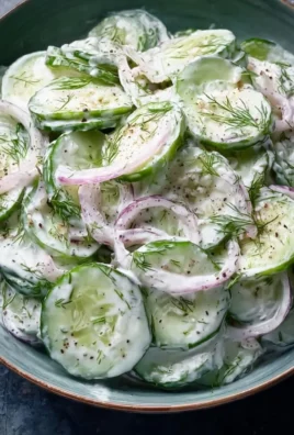 Delicious creamy cucumber salad served in a bowl with fresh herbs