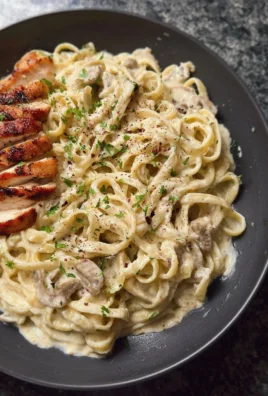 Creamy white sauce pasta dish with herbs and cheese garnishing
