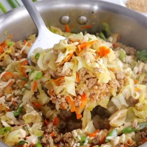 Delicious egg roll in a bowl filled with fresh vegetables and savory meat