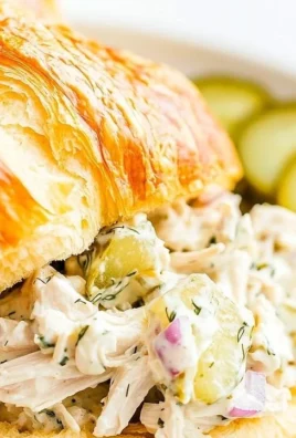 Flavored dill pickle chicken salad served in a bowl with fresh ingredients