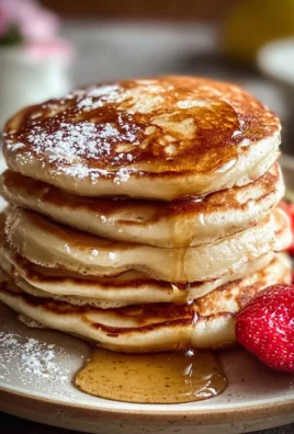 Fluffy Greek Yogurt Pancakes stacked on a plate with fresh fruits