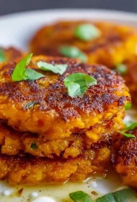 Healthy sweet potato hash browns served on a plate with herbs