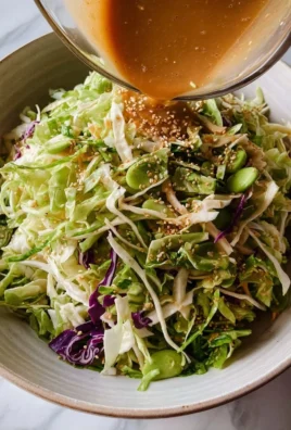 A vibrant bowl of Japanese cabbage salad garnished with sesame seeds and dressing