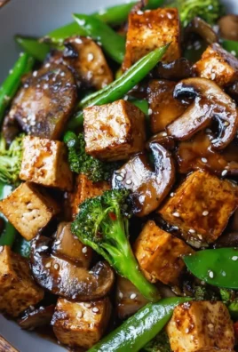 Mushroom Tofu Stir-Fry served in a bowl, garnished with vegetables.