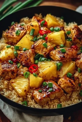 Pineapple chicken served on a bed of rice with vibrant vegetables