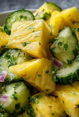 A vibrant pineapple cucumber salad served in a bowl with fresh ingredients.
