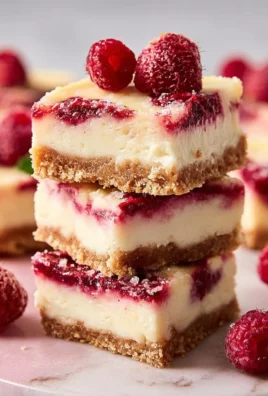 Delicious Raspberry Cheesecake Bars with a creamy filling and raspberry topping