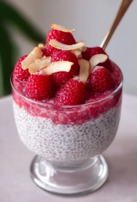 Delicious Raspberry Chia Pudding in a glass topped with fresh raspberries