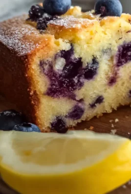 Soft and moist lemon blueberry yogurt cake topped with fresh blueberries