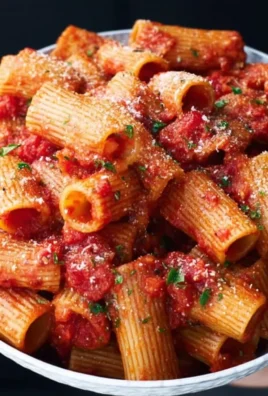 Delicious Spicy Rigatoni dish served with fresh herbs and chili flakes