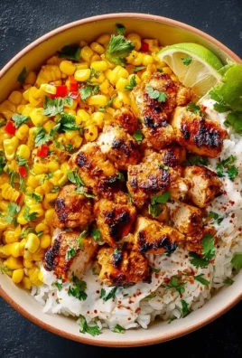 Street Corn Chicken Rice Bowl topped with cheese and cilantro on a bed of rice.