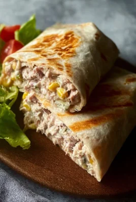 Tuna melt wrap filled with tuna, cheese, and fresh vegetables