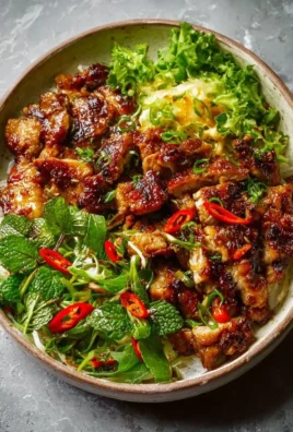 Plate of Vietnamese Lemongrass Chicken garnished with fresh herbs