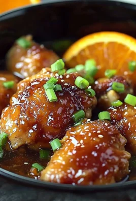 Bowl of Asian Crockpot Orange Chicken served with rice and vegetables
