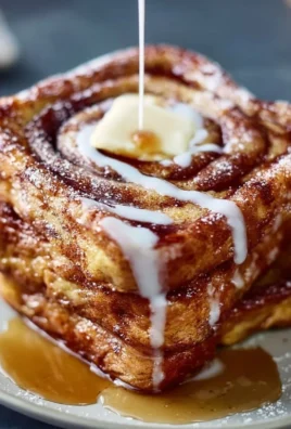 Delicious cinnamon roll French toast topped with icing and berries