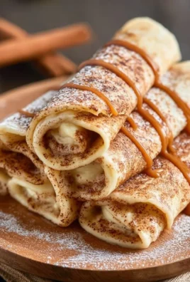Delicious cinnamon roll protein crepes topped with icing and cinnamon