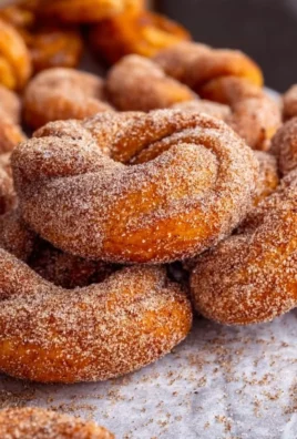 Freshly baked Cinnamon Sugar Twist Donuts dusted with cinnamon and sugar