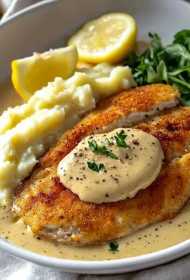 Delicious creamy Chicken Schnitzel with golden crust and savory sauce