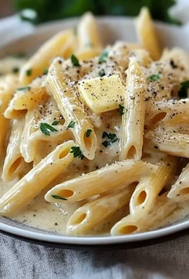 Creamy garlic penne pasta served with fresh herbs and grated cheese