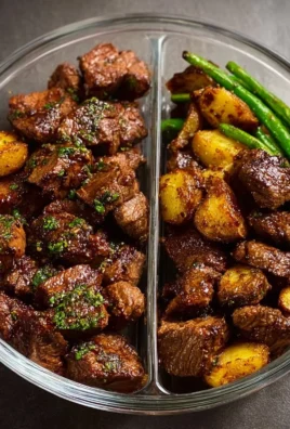 Garlic balsamic steak bites served on a plate, garnished with herbs