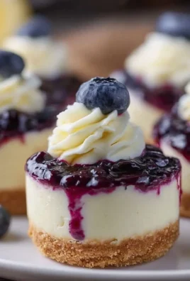 Healthy mini lemon blueberry cheesecakes on a white plate garnished with blueberries