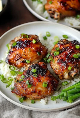 Plate of roasted miso chicken thighs garnished with herbs