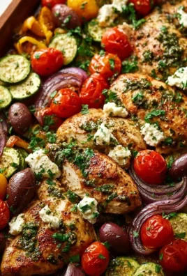 Sheet pan Mediterranean chicken with colorful vegetables and herbs.