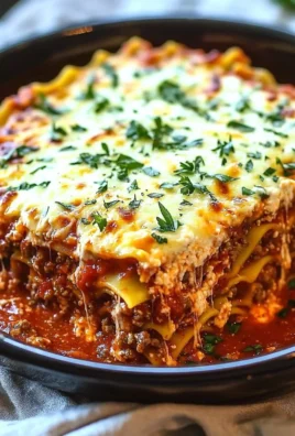 Delicious simple Crockpot Lasagna in a slow cooker with layered pasta and cheese.