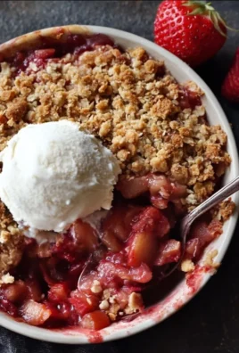 Delicious strawberry rhubarb crisp dessert topped with crunchy oat topping