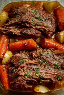 Tender pot roast served with vegetables and gravy
