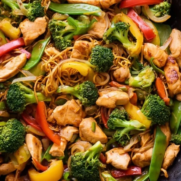 Colorful chicken stir fry with vegetables in a wok