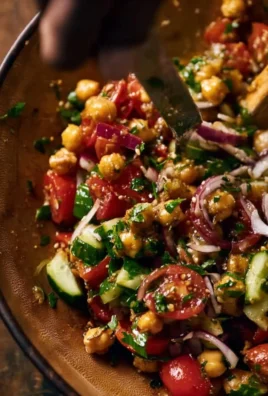 A bowl of Turkish Chickpea Salad with fresh vegetables and herbs.