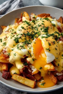 Ultimate breakfast poutine topped with creamy hollandaise sauce
