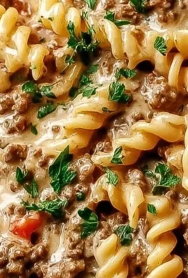 Creamy ground beef pasta dish served in a bowl with herbs
