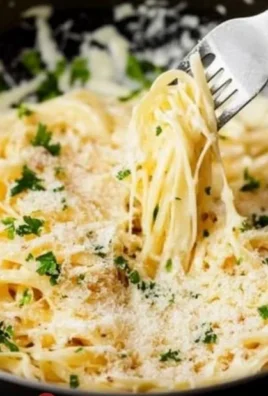 Delicious bowl of Garlic Parmesan Pasta topped with fresh herbs and cheese