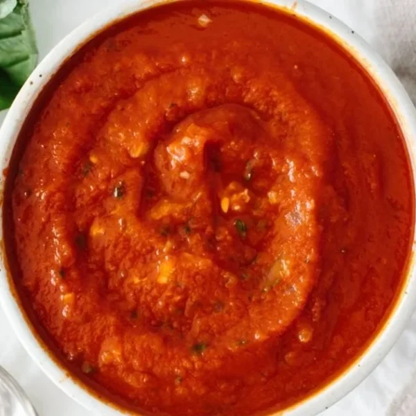 Homemade marinara sauce simmering with fresh tomatoes and herbs