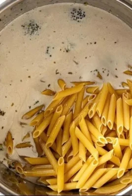 Bowl of creamy garlic pasta made in an Instant Pot, garnished with parsley.