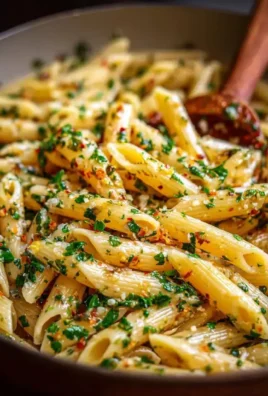 Plate of Italian pasta with garlic olive oil sauce garnished with parsley