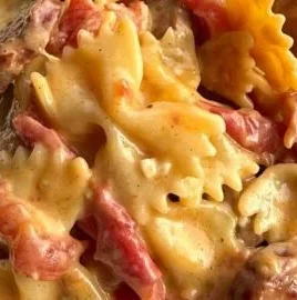 One Pot Creamy Cajun Sausage Pasta served in a bowl with fresh herbs
