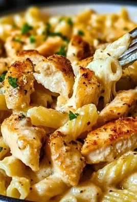 Delicious One Pot Garlic Parmesan Chicken Pasta in a bowl with herbs on top